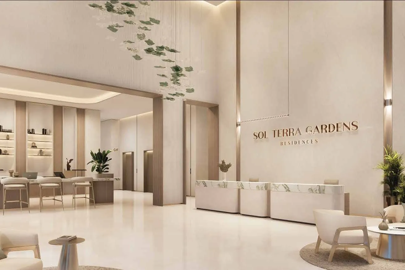 Double-height lobby with marble reception desk and leaf chandelier